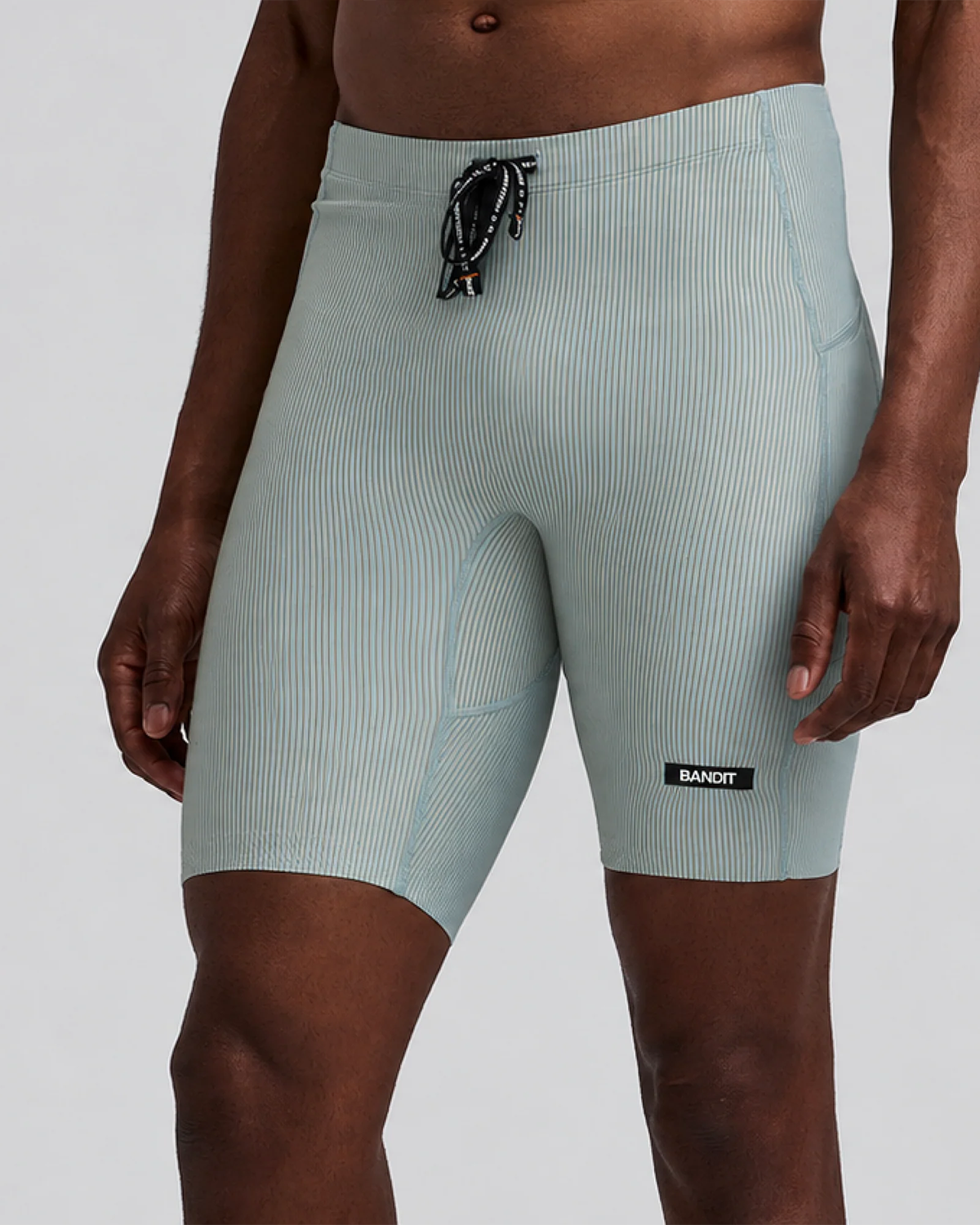 BANDIT RUNNING STRIPED CADENCE™ HALF TIGHTS LAGOON / COPAL